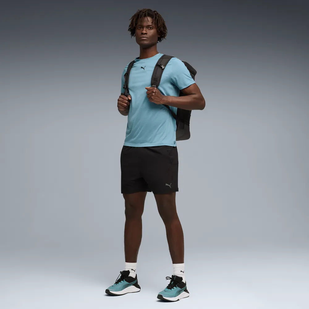 PUMA TAD Essential Short Sleeve Tee Mens - Baltic Sea Blue, model with backpack lifestyle shot