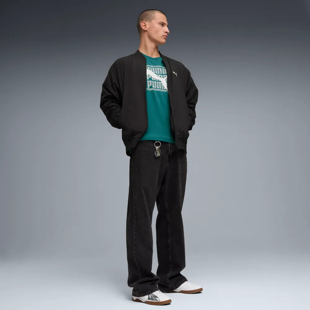 PUMA GRAPHIC WORDING SHORT SLEEVE TEE MENS - Emerald Ice, lifestyle full body front view worn by model with jacket